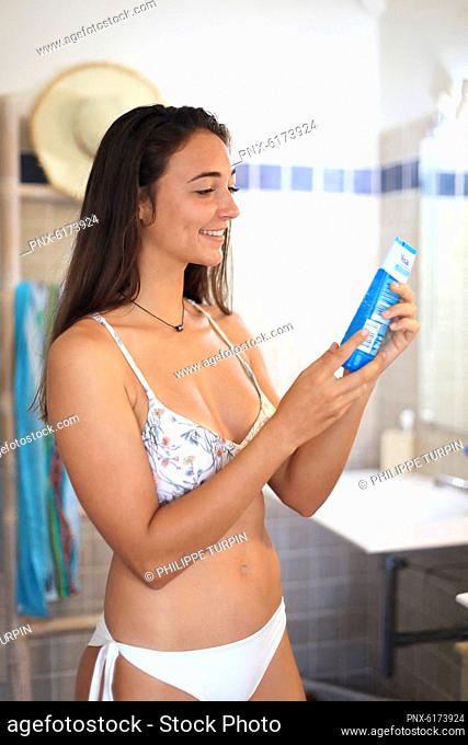 Young woman and after sun cream