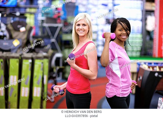 Two young women lifting weights, Pietermaritzburg, KwaZulu-Natal, South Africa