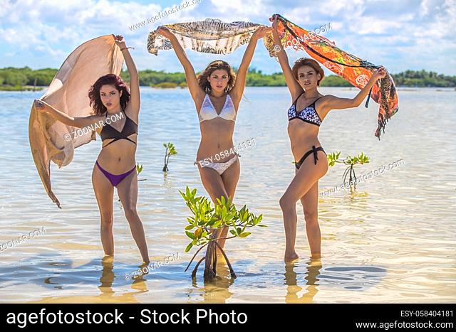 Beautiful hispanic models enjoying a day at the beach