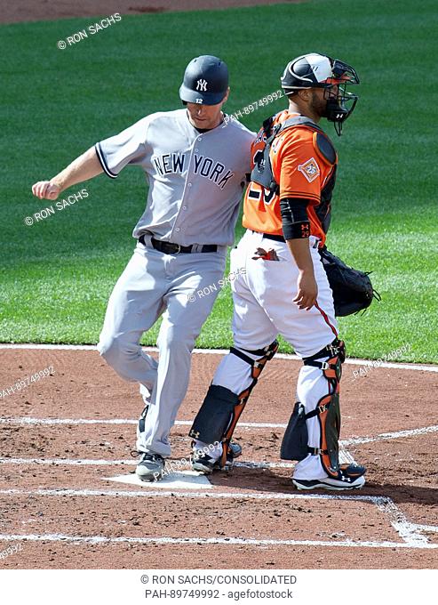New York Yankees third baseman Chase Headley (12) scores the Yankees first run on a Ronald Torreyes single in the second inning against the Baltimore Orioles at...