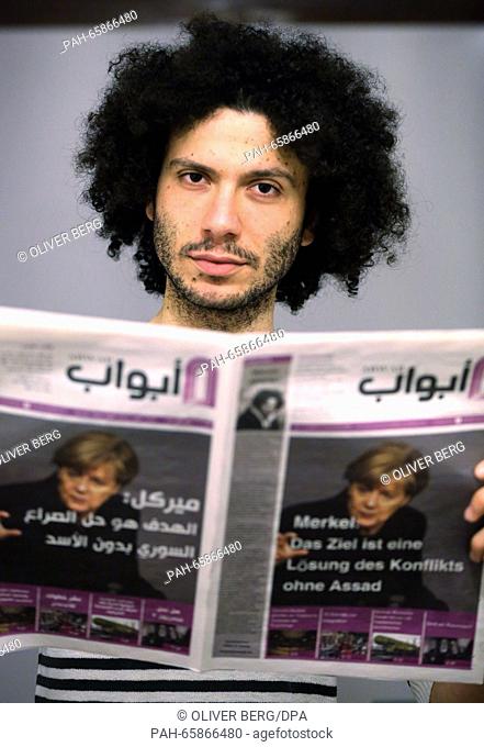 Chief editor of the newspaper 'Abwab', Ramy Al-Asheq a refugee from Syria, holds a print edition of his paper in his hands in Cologne, Germany, 19 February 2016