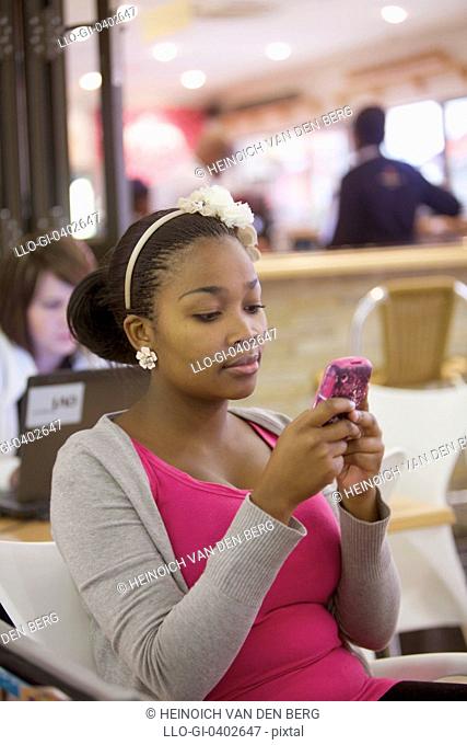 A young woman using her cellphone, Pietermaritzburg, KwaZulu-Natal, South Africa