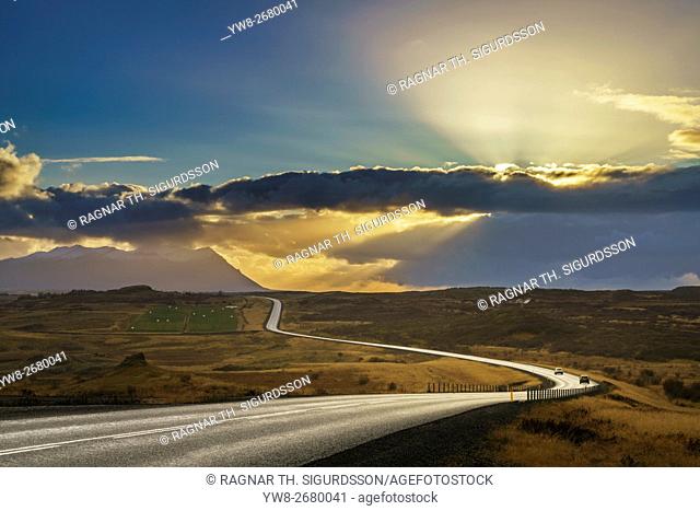 Empty curvy road at sunset. Route one in a rural area, Borgarfjordur fjord, Iceland