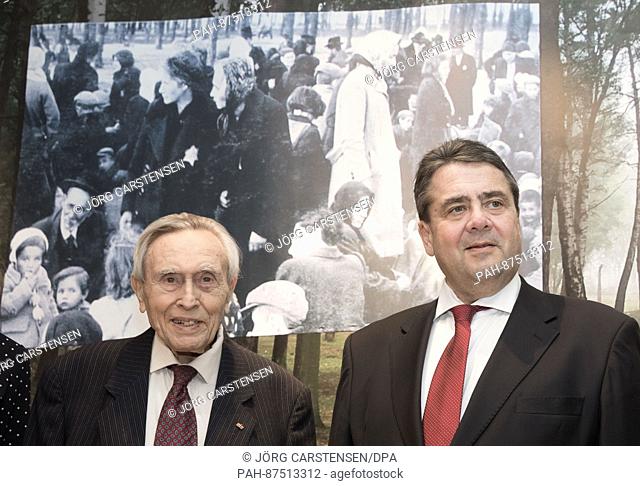 The Holocaust and Auschwitz survivor Felix Kolmer (L) and the Federal Minister of Economy Sigmar Gabriel stand in the exhibition ""Shoes