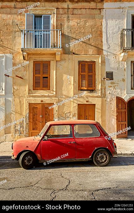 VALLETTA, MALTA - OCTOBER 30, 2017: Old vintage car in front of typical traditional house in Valletta in Malta