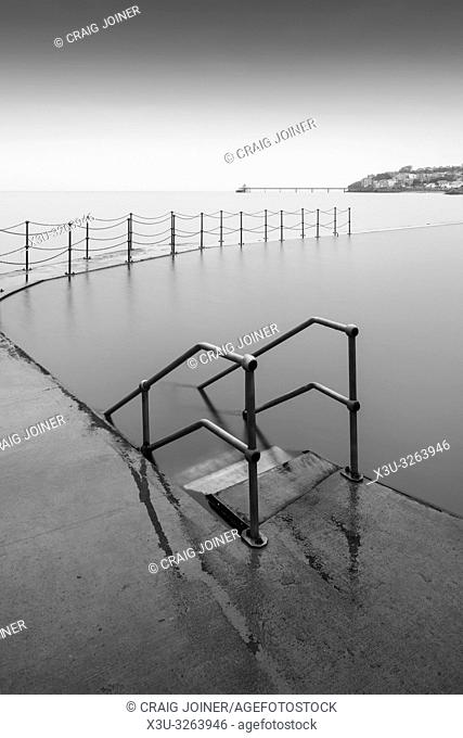 The Marine Lake at Clevedon with the Victorian pier in the Severn Estuary beyond. North Somerset, England