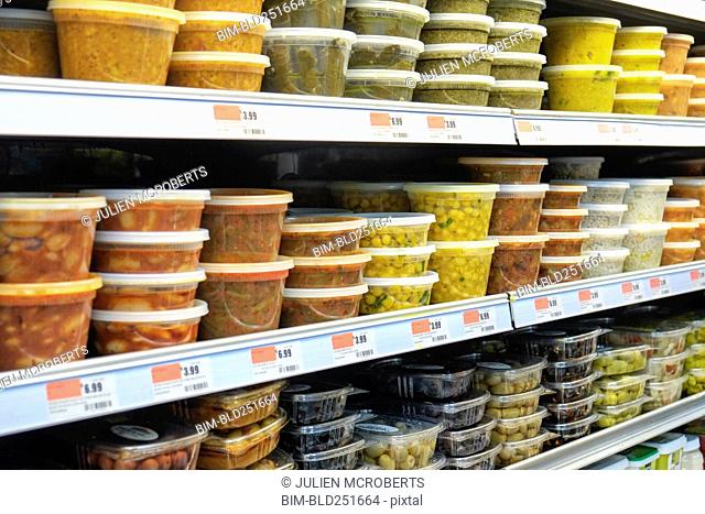 Plastic containers of food on supermarket shelves