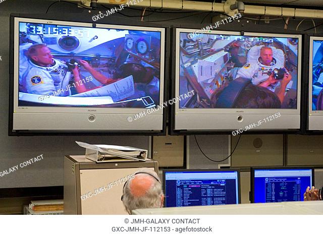 NASA astronaut Tim Kopra, STS-133 mission specialist, is visible on the screens in the Space Station Airlock Test Article (SSATA) Control Room in the Crew...