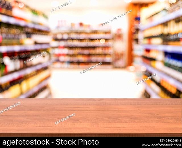 Wooden board empty table in front of blurred background. Perspective dark wood over blur in supermarket - can be used for display or montage your products