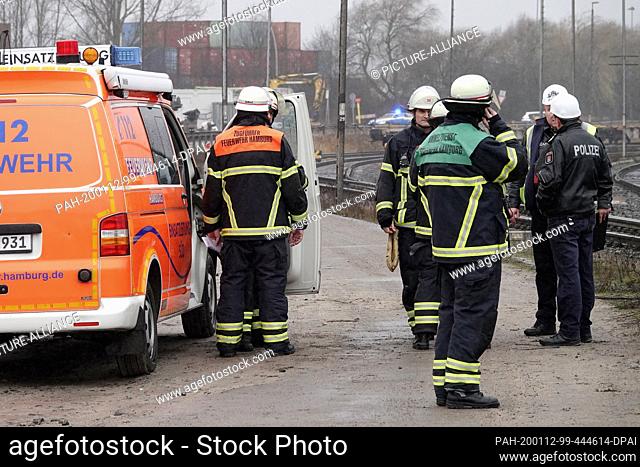 12 January 2020, Hamburg: Emergency services wearing respiratory masks are deployed in the port area along a railway line