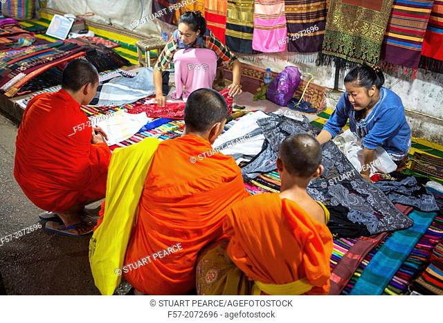Monks buying fabric at the night market in Luang Prabang, Laos