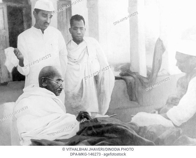 Mahatma Gandhi sitting in front of the main building at Rashtriyashala Ashram ; Rajkot ; during his fast ; 1939 ; Purushottam Gandhi ; Brijkrishna Chandiwalla...
