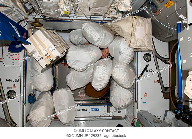 NASA astronaut Don Pettit, Expedition 30 flight engineer, is pictured among stowage bags in the Harmony node of the International Space Station