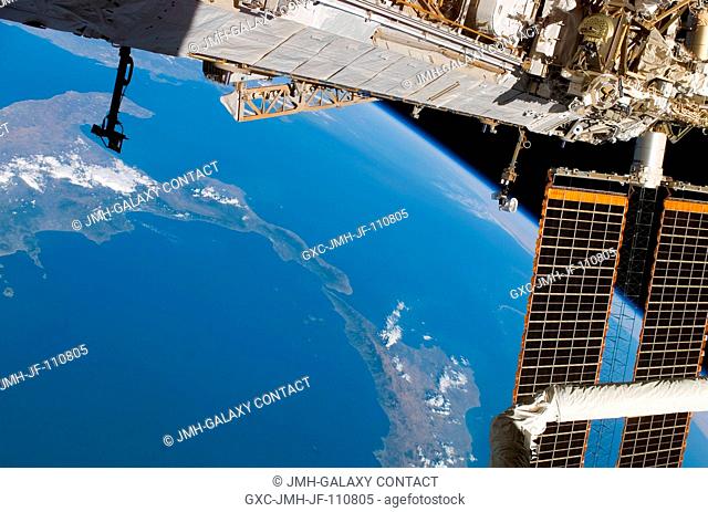 A portion of the International Space Station frames this view of the lower portion of Italy and a portion of Sicily, photographed by a STS-118 crewmember while...