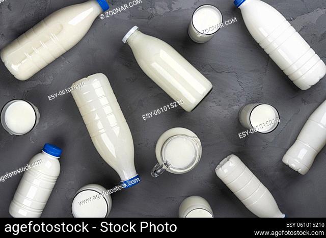 Dairy products packaging pattern, collection of milk bottles on gray stone background, top view