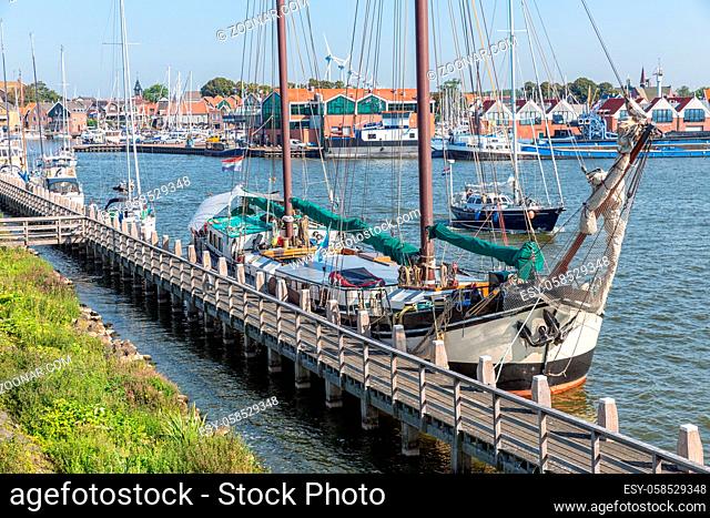Historic sailing ship moored at pier of Dutch fishing village Urk