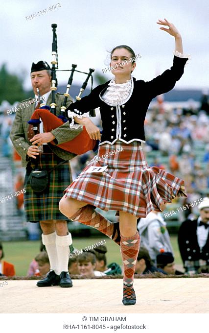Scottish girl in tartan kilt dancing traditional dance at the Braemar Royal Highland Gathering, the Braemar Games in Scotland