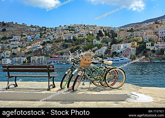Three bicycles and view of the houses in Symi, Symi Island, Greece, Europe