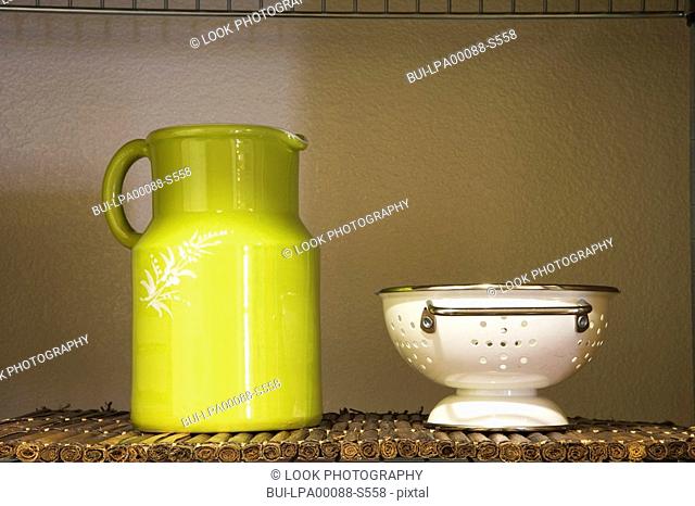Green Pitcher and White Strainer on Shelf