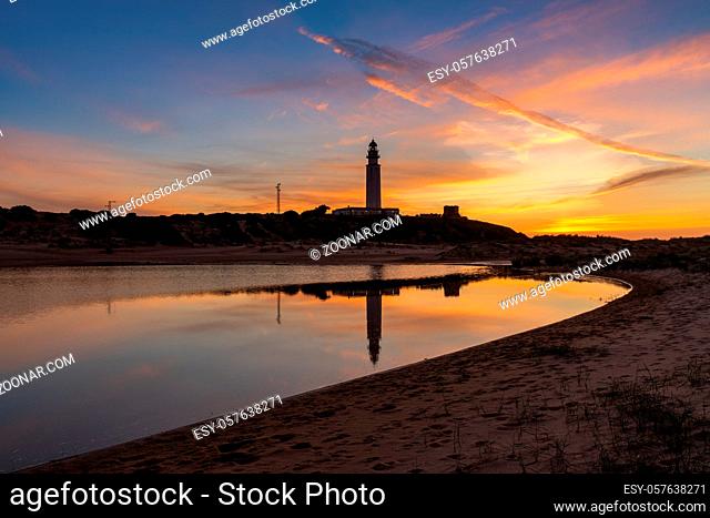A view of the Cape Trafalgar lighthouse after sunset with colorful evening sky