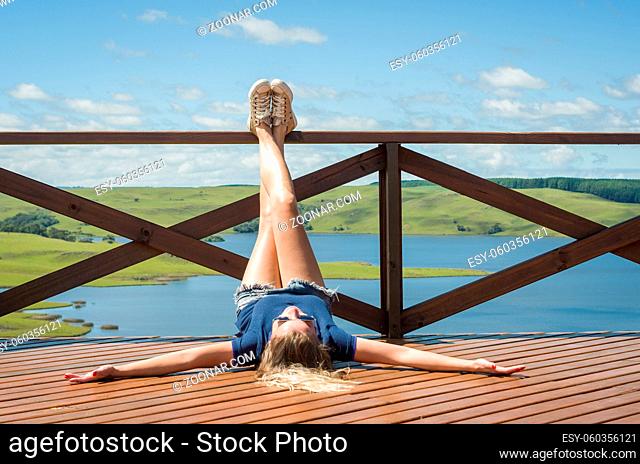 Great concept of freedom, woman legs up on balcony