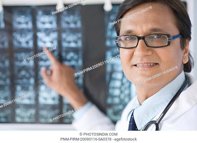 Doctor examining an x-ray report, Gurgaon, Haryana, India