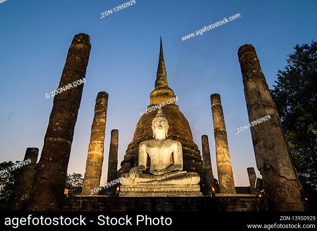 a Buddha with a stupa at the Wat Sa Si Temple at the Historical Park in Sukhothai in the Provinz Sukhothai in Thailand.  Thailand, Sukhothai, November, 2018
