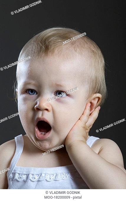 Portrait of baby girl yawing