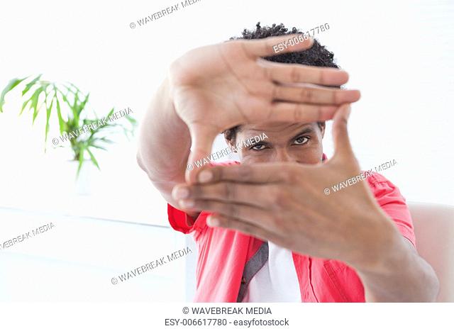 Businessman posing with hands making a frame