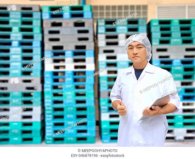 A man in white great coat uniform and Plastic Pallets of background for Concept design Quality Inspection Business