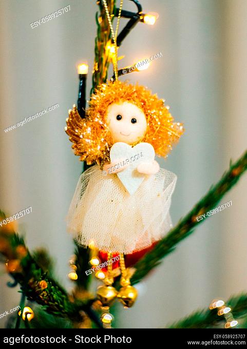 Christmas angel on a wooden table on a background of trees