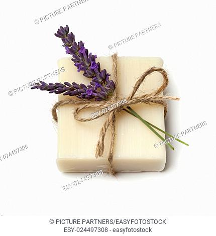 Piece of lavender soap and fresh lavender on white background