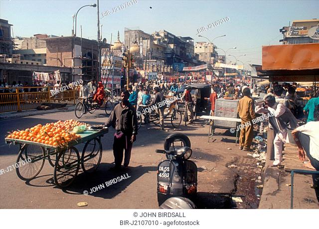 Chandni Chowk, a main shopping street in Delhi, India, with fruit stall in foreground