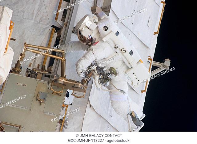 NASA astronaut Michael Fincke participates in the mission's fourth session of extravehicular activity (EVA) as construction and maintenance continue on the...