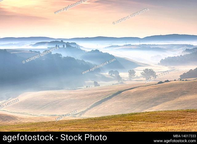tuscan landscape, morning with fog in the valleys and rolling hills of the crete senesi, asciano, province of siena, tuscany, italy
