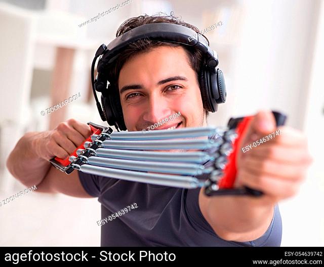 The man doing sports with resistance band and listening to music
