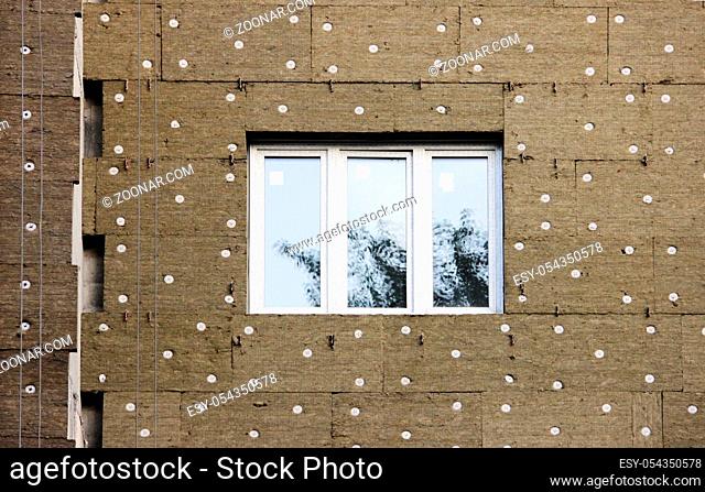 windows in a newly built house. wall structure with insulated non-combustible material basalt fiber tiled