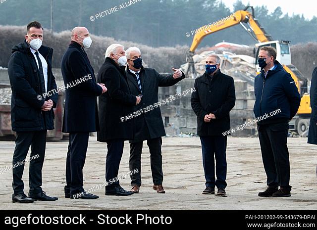 02 December 2020, Brandenburg, Oranienburg: Federal President Frank-Walter Steinmeier (3rd from left) is shown around the company premises during a visit to...