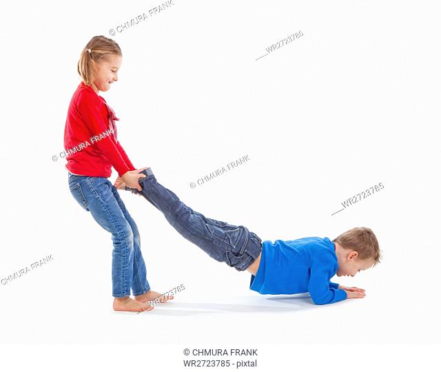 brother and sister having fun with each other - isolated on white