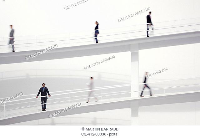 Blurred business people walking on elevated walkways