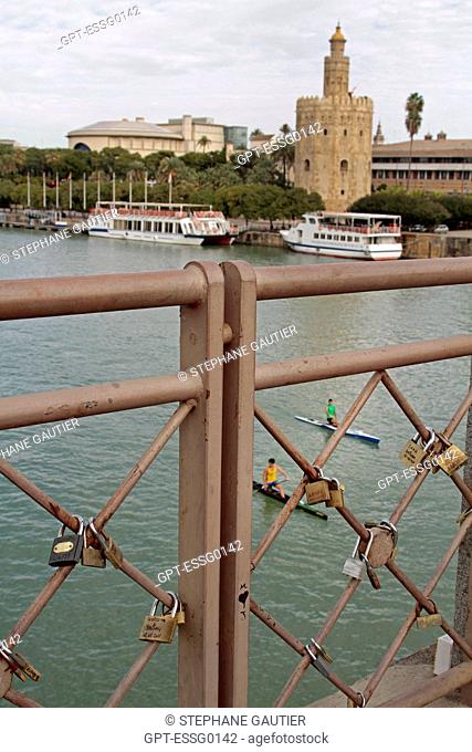 LOVE PADLOCKS ALONG THE GUADALQUIVIR RIVER, LA TORRE DEL ORO TOWER OF GOLD, FORMER MILITARY OBSERVATION TOWER BUILT AT THE START OF THE 13TH CENTURY AND TODAY A...