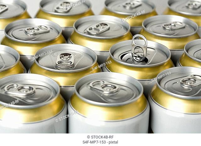 Row of beer cans with one opened can, Germany