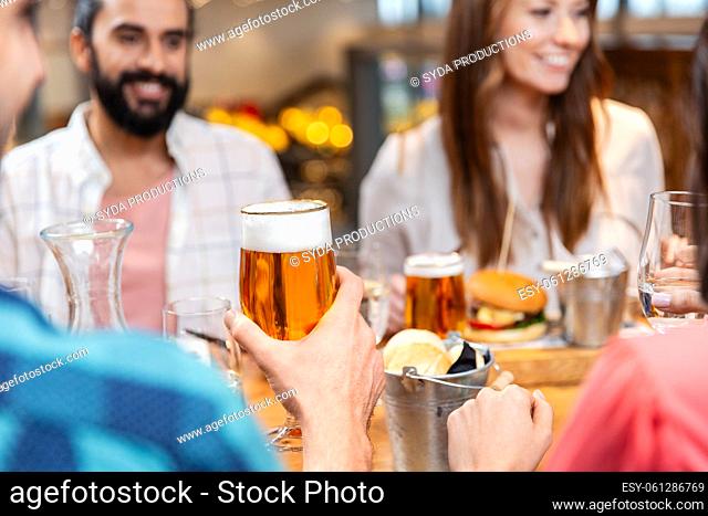 friends dining and drinking beer at restaurant