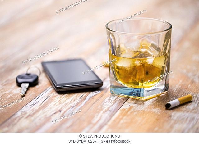 close up of alcohol and car key on table