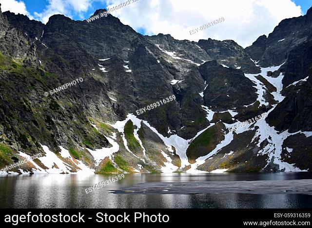 Lake Czarny staw pod rysami, near Morskie oko, and Tatra mountains, with some ice and snow still in June. Poland