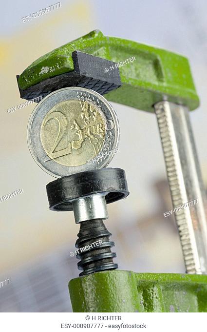 Two Euro coin in a green clamp