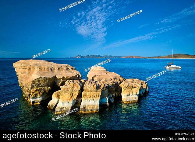 White rocks of famous tourist attraction of Milos island Sarakiniko beach and yacht boat at Sarakiniko Beach, Milos island, Greece, Europe