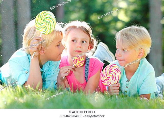 Happy children with lollipops