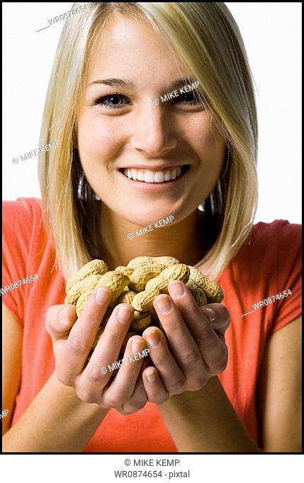 woman with a handfull of peanuts