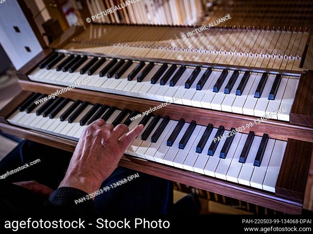 02 May 2022, Mecklenburg-Western Pomerania, Pinnow: The keyboard of the new organ for the 14th century village church is installed by employees of a special...